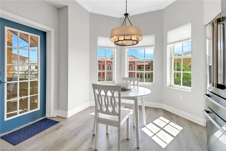 Dining room with a chandelier, a healthy amount of sunlight, and wood finished floors