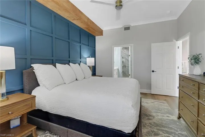 Bedroom with ornamental molding, and light wood-type flooring
