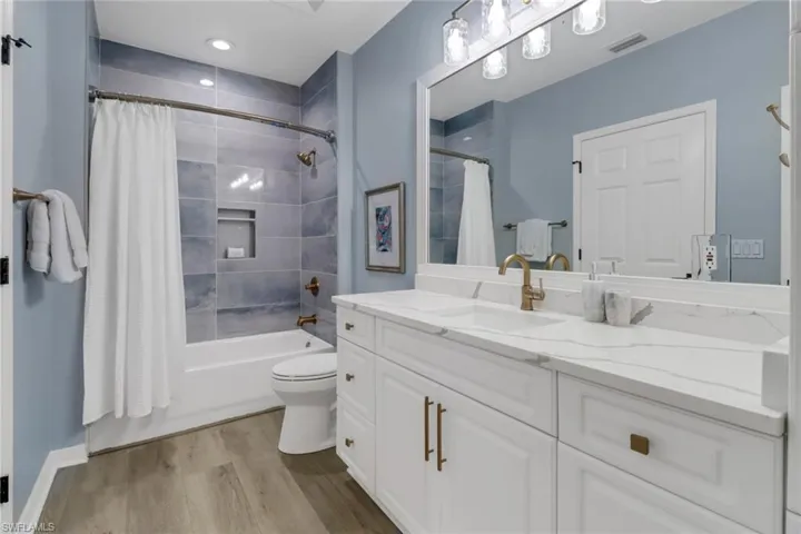 Full bath with vanity, shower / tub combo