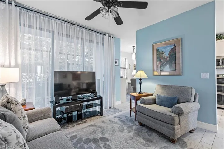 Living room with a wealth of natural light and ceiling fan