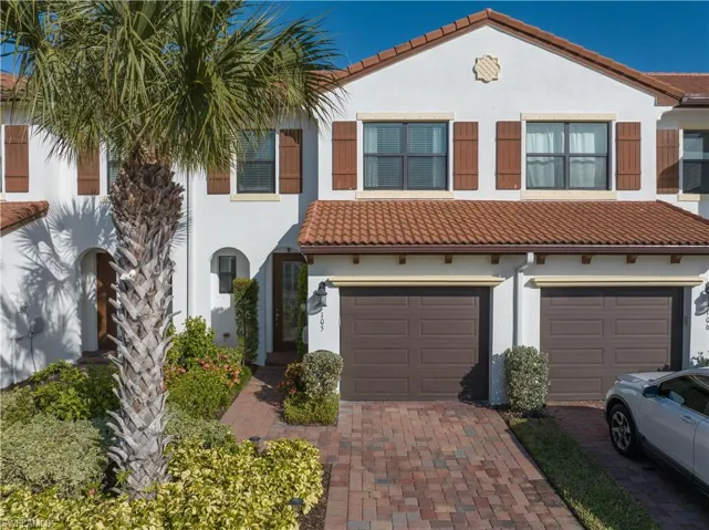 Mediterranean / spanish home with a garage