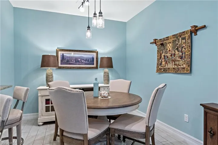 Dining room with light plank tile flooring