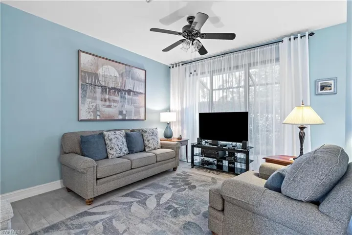 Living room with plank tile flooring and ceiling fan