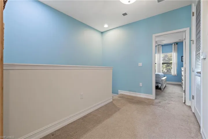 Reverse view of landing featuring light carpet