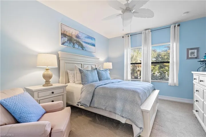 Primary Bedroom featuring ceiling fan and light carpet