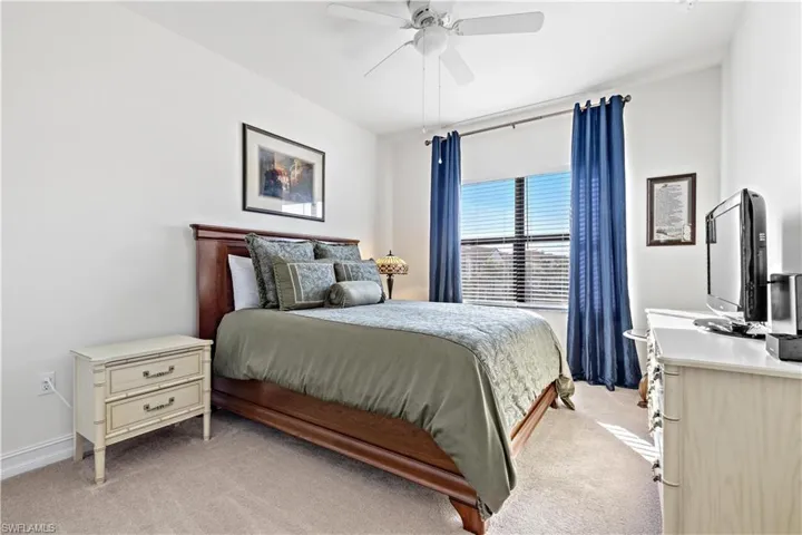Guest bedroom One featuring carpet flooring and ceiling fan