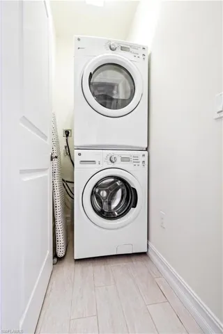 Laundry room featuring stacked washer and dryer