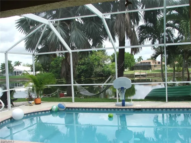 Swimming pool with glass enclosure and a water view