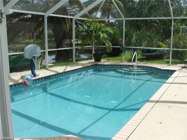 Outdoor pool with glass enclosure and a patio