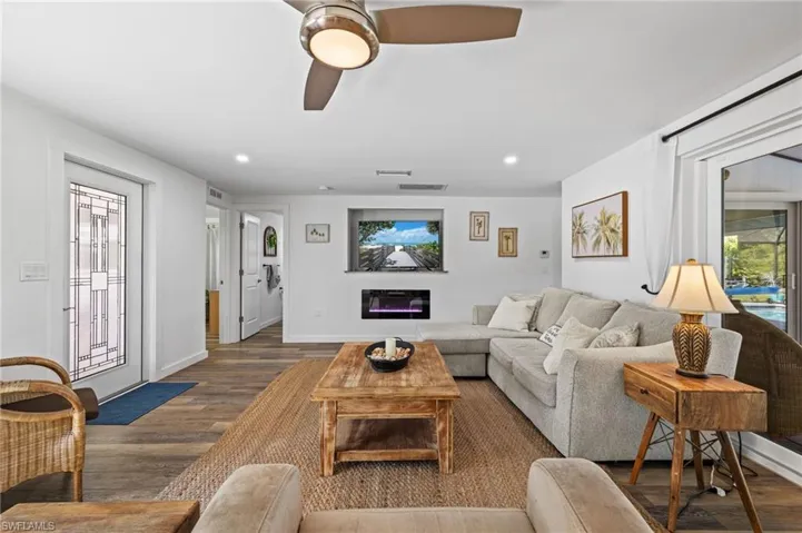 Wood-finish flooring throughout, with a decorative glass-paneled entry door