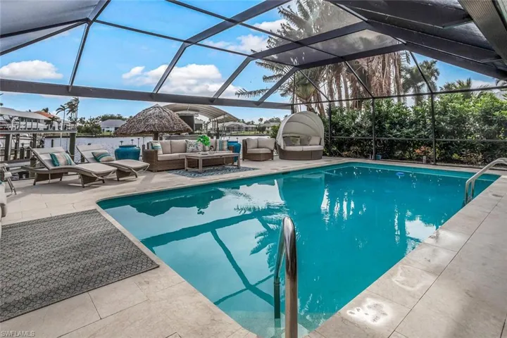 View of pool with an outdoor hangout area, a patio, and a lanai