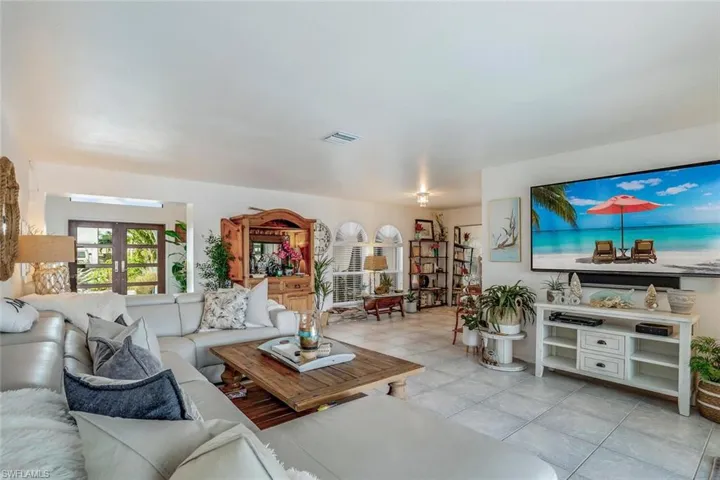 Living room featuring french doors and light tile patterned floors