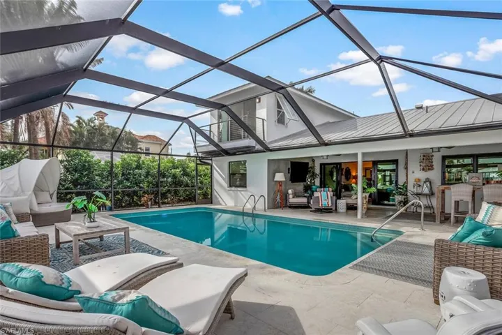 View of swimming pool featuring outdoor lounge area, ceiling fan, and a patio area