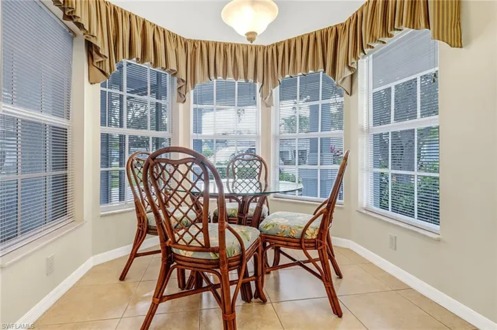 Dining space with a wealth of natural light and light tile patterned floors