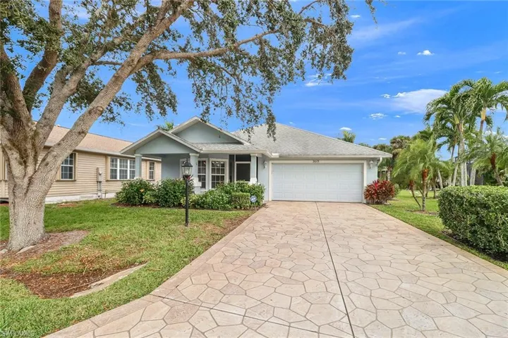 Single story home featuring a front lawn and a garage