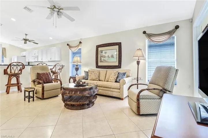 Living room featuring ceiling fan and light tile patterned flooring