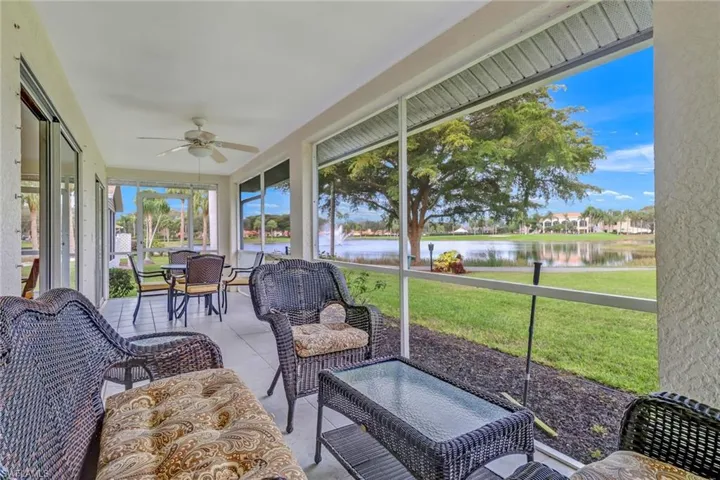 Sunroom featuring a water view and ceiling fan
