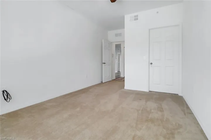 Unfurnished bedroom featuring carpet flooring and ceiling fan