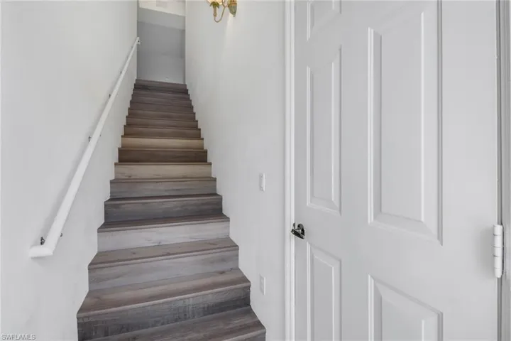 Stairway featuring hardwood / wood-style flooring