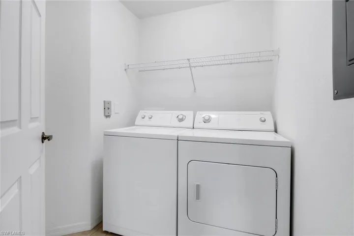 Laundry room with washing machine and clothes dryer