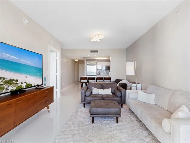 Living room toward kitchen and entry