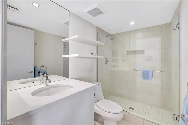 Bathroom featuring vanity, a stall shower, and recessed lighting