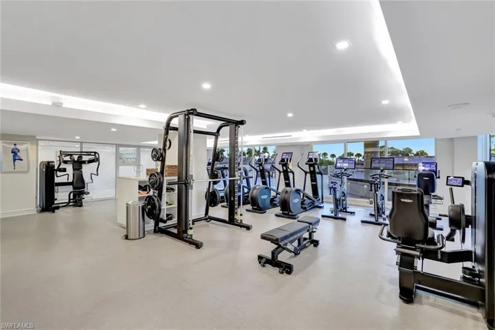 Gym with expansive windows and recessed lighting