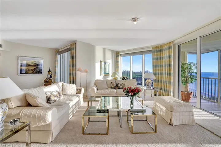 Living area with carpet floors and a wall of windows