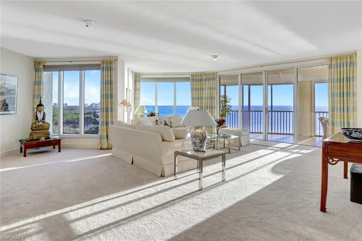 Carpeted living room with a water view