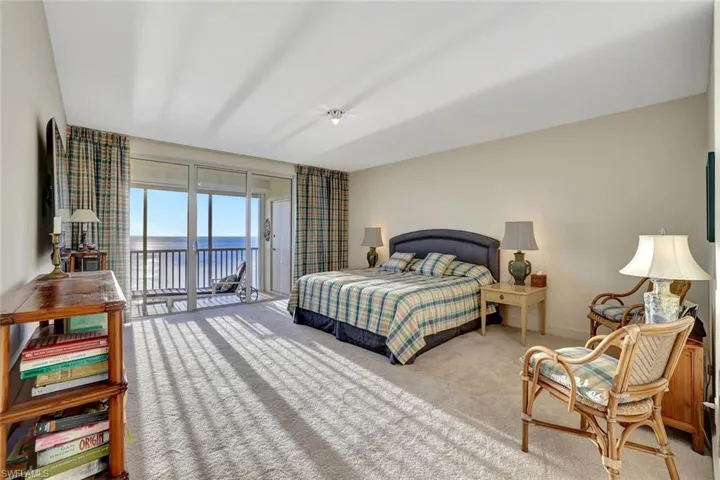 Bedroom featuring light carpet and access to exterior
