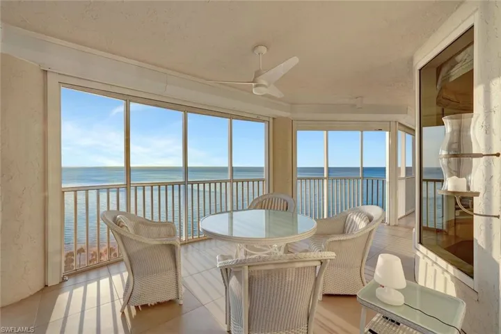 Sunroom / solarium featuring a water view and tile patterned floors