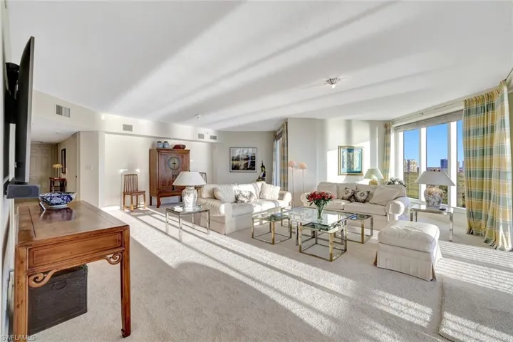 Carpeted living area with a wood stove