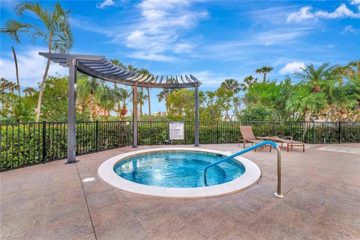 View of pool with a hot tub and a patio area