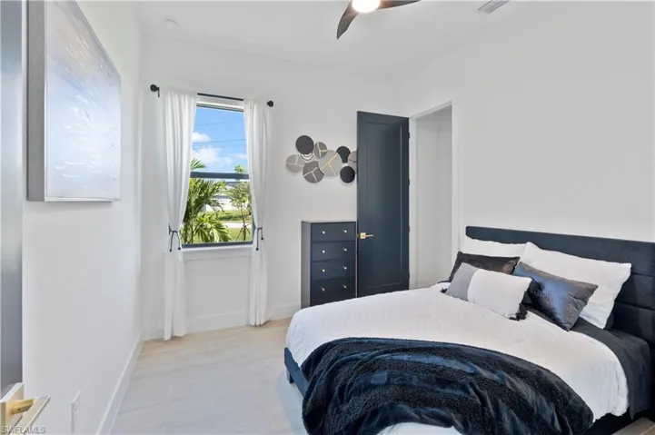 Bedroom with light wood-type flooring and a ceiling fan