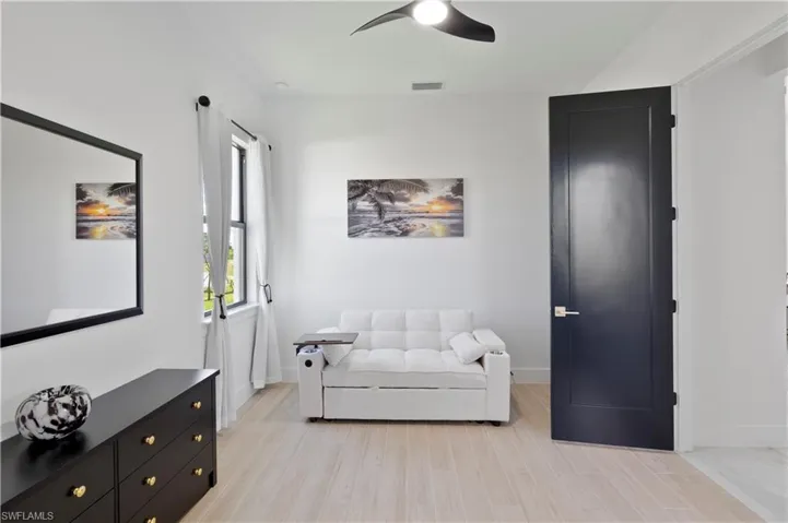 Living area featuring a ceiling fan and light wood finished floors