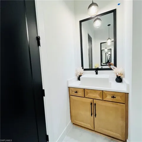 Bathroom with vanity and baseboards