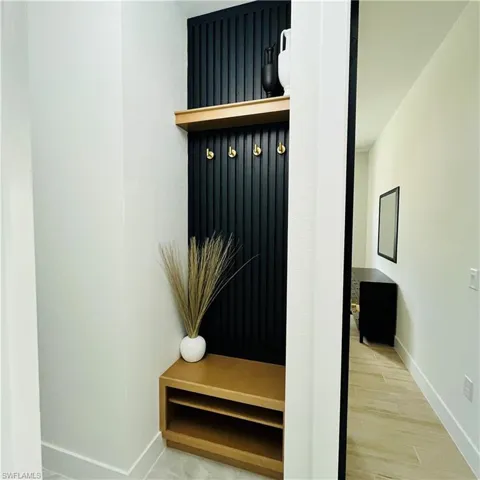 Mudroom with baseboards and light wood-style flooring
