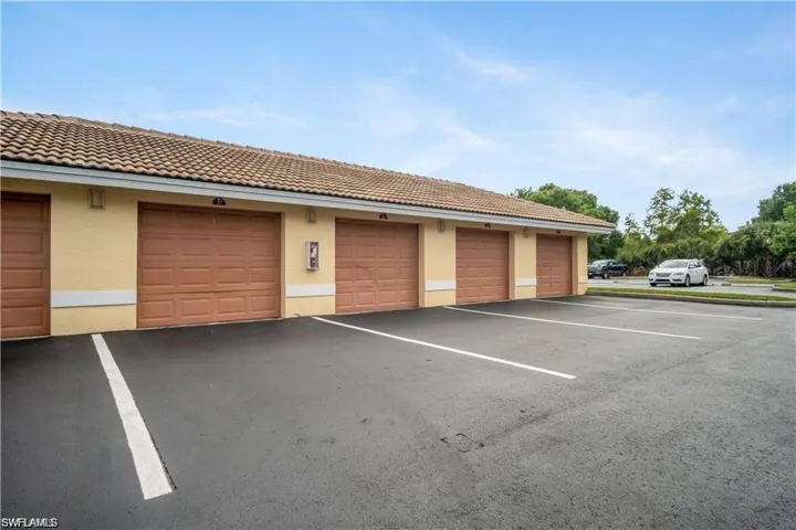 View of vehicle parking with a garage