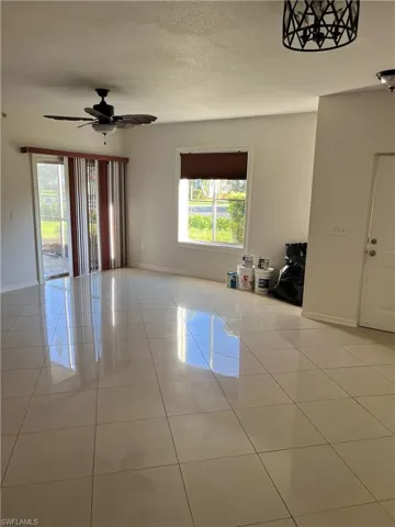 Spare room featuring light tile patterned flooring and ceiling fan