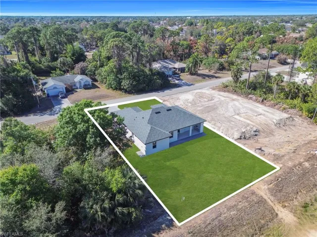 Aerial view of property and surrounding area with property parcel outlined