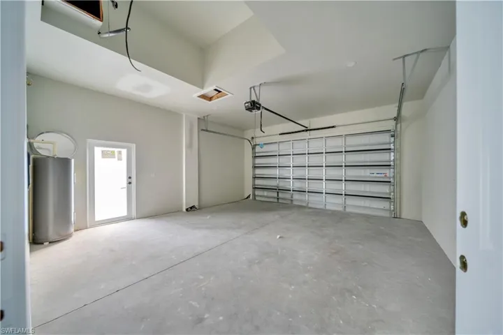 Garage with water heater and a garage door opener