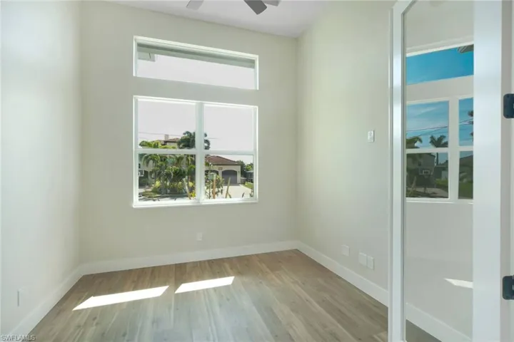 Spare room featuring light wood-style flooring and a ceiling fan