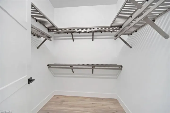 Spacious closet featuring light wood-type flooring