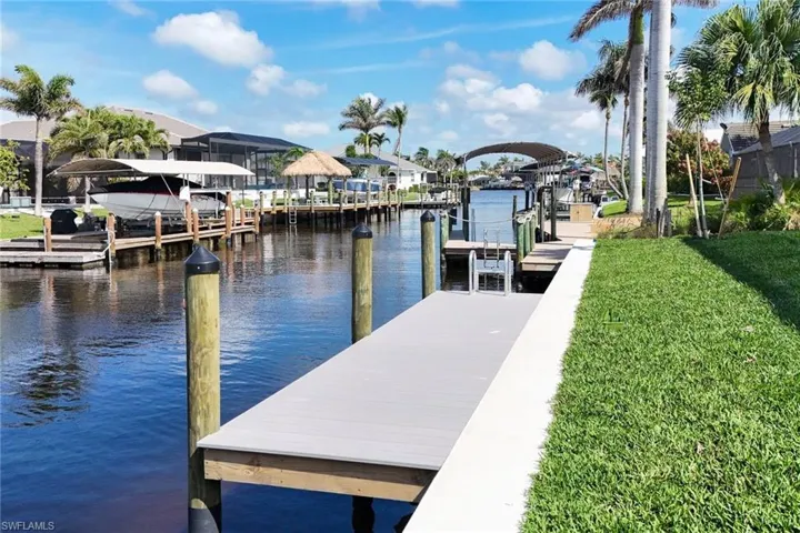 Dock with a yard, a water view, and a residential view