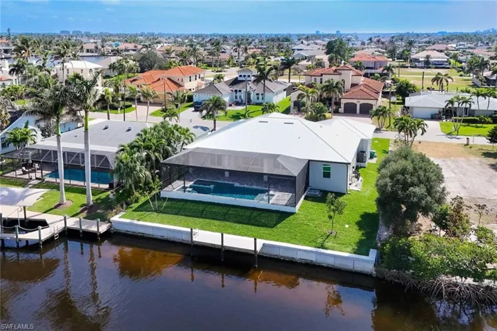 Aerial view of residential area featuring a large body of water