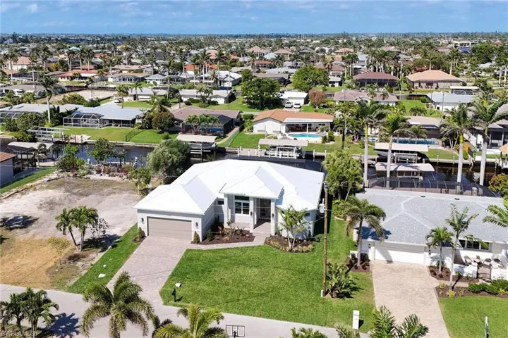 Aerial perspective of suburban area featuring a nearby body of water