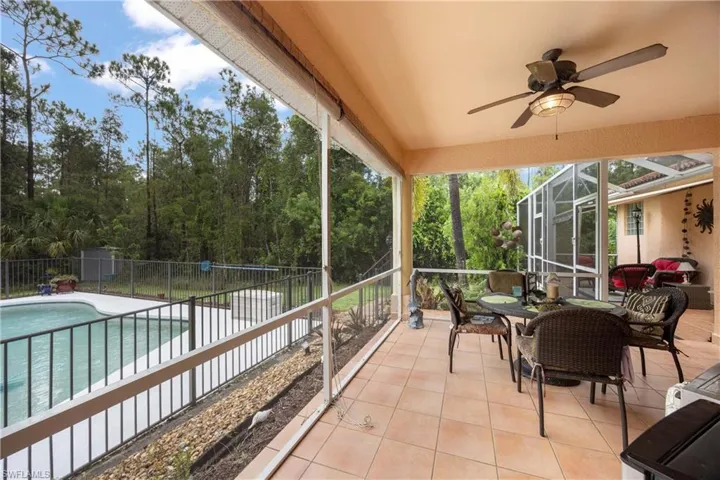 Sunroom / solarium featuring a ceiling fan and outdoor dining space