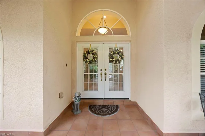 Property entrance with french doors and stucco siding