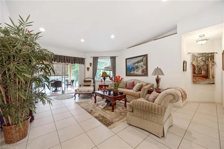 Living area featuring light tile patterned floors and recessed lighting