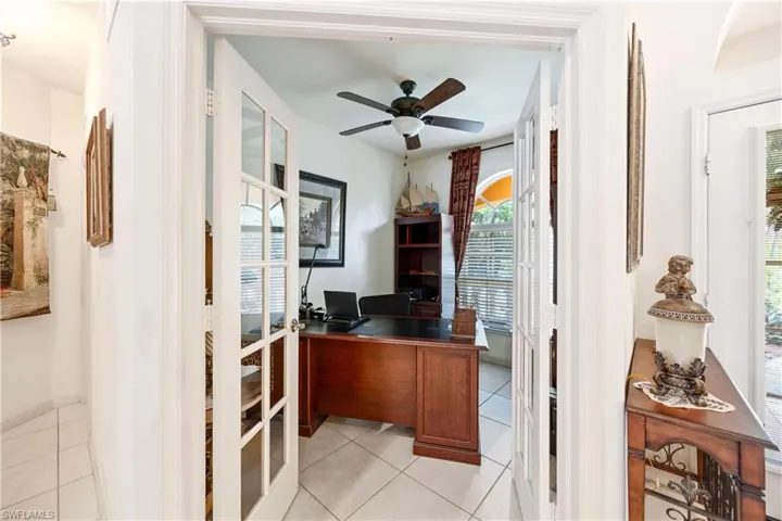 Office with light tile patterned flooring, ceiling fan, and french doors